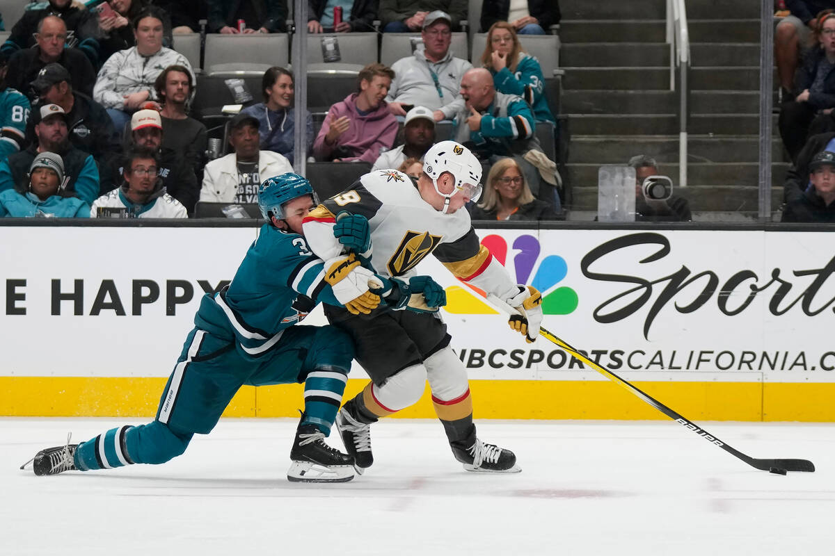 Vegas Golden Knights center Ivan Barbashev, right, reaches for the puck in front of San Jose Sh ...