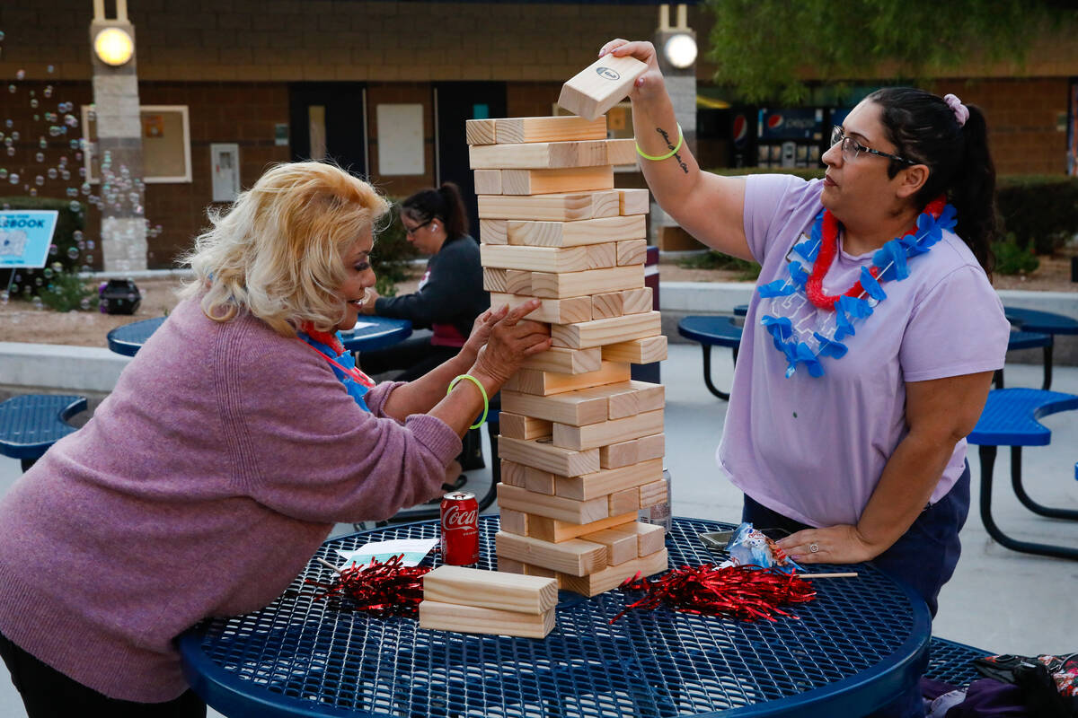 Angie Altamirano, right, and Roberta Alegria work together to solve a puzzle at a launch event ...