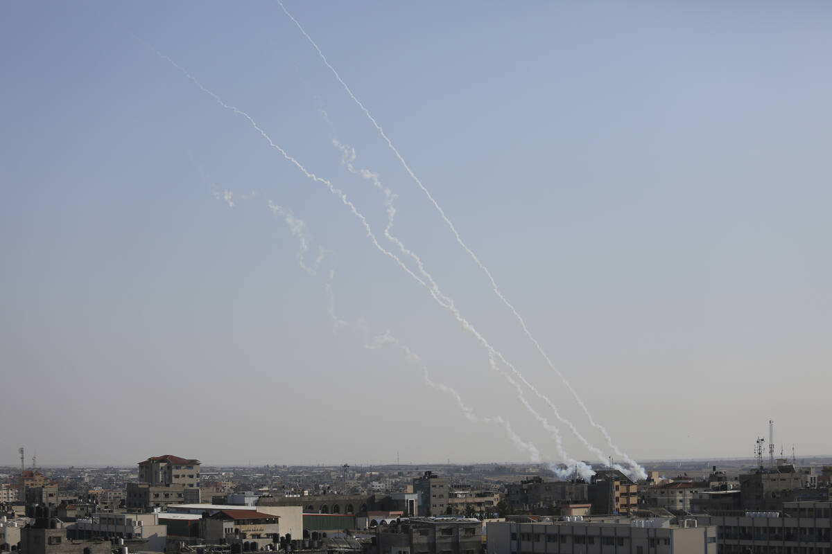 Rockets are fired toward Israel from the Gaza Strip, in Rafah, southern Gaza Strip, Thursday, O ...
