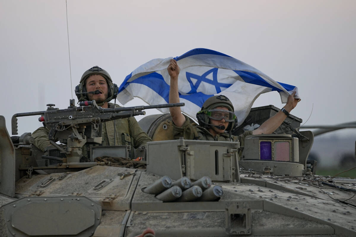 Israeli tanks head towards the Gaza Strip border in southern Israel on Thursday, Oct.12, 2023. ...