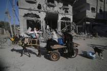 Palestinians leave their houses following Israeli airstrikes in Rafah refugee camp, southern Ga ...