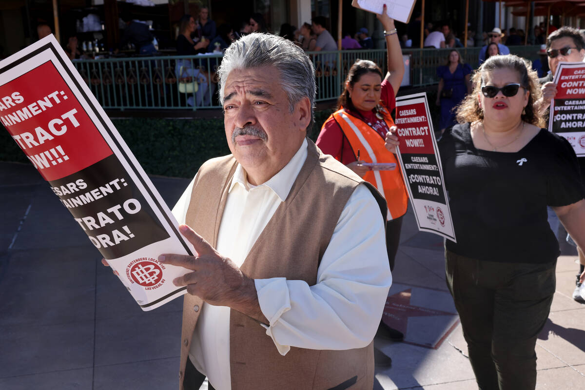 Members of Culinary Local 226, including banquet server Salomon Romero, left, picket in front o ...