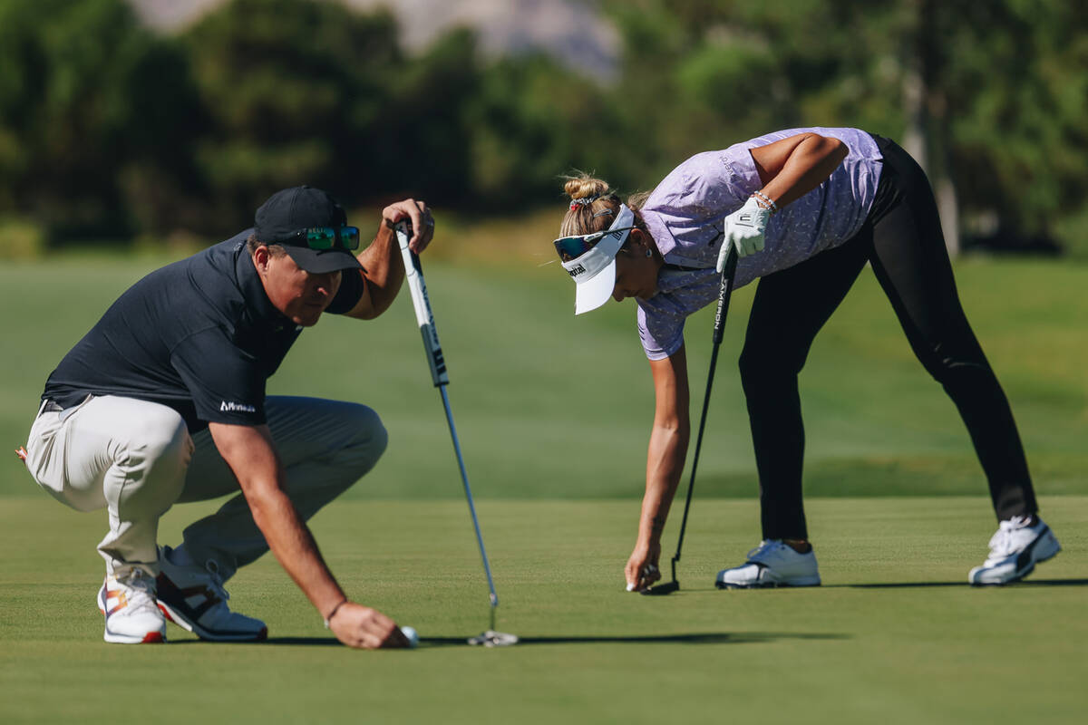 Lexi Thompson, right, gets ready to putt her ball on the first green during the Shriners Childr ...