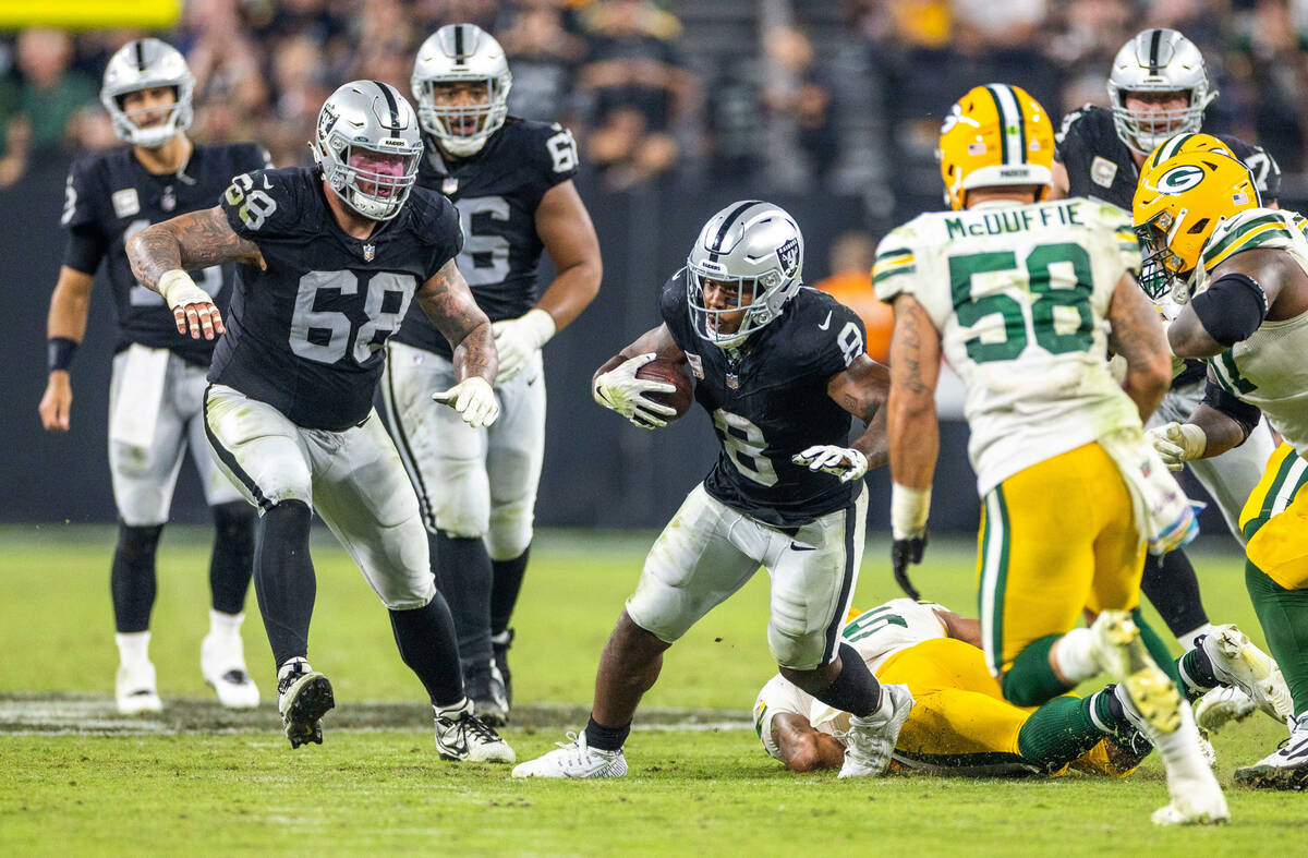 Raiders running back Josh Jacobs (8) breaks up field after a catch as Green Bay Packers linebac ...