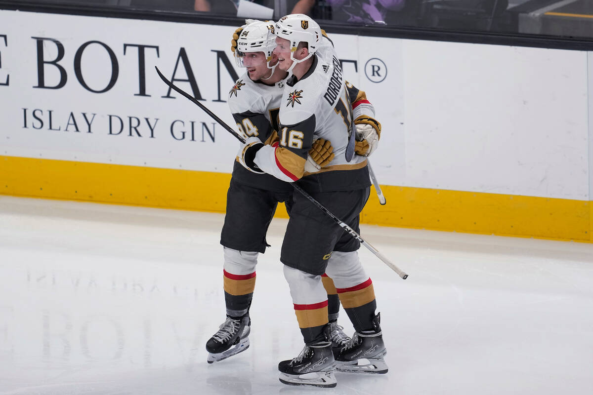 Vegas Golden Knights defenseman Brayden Pachal, left, is congratulated by left wing Pavel Dorof ...