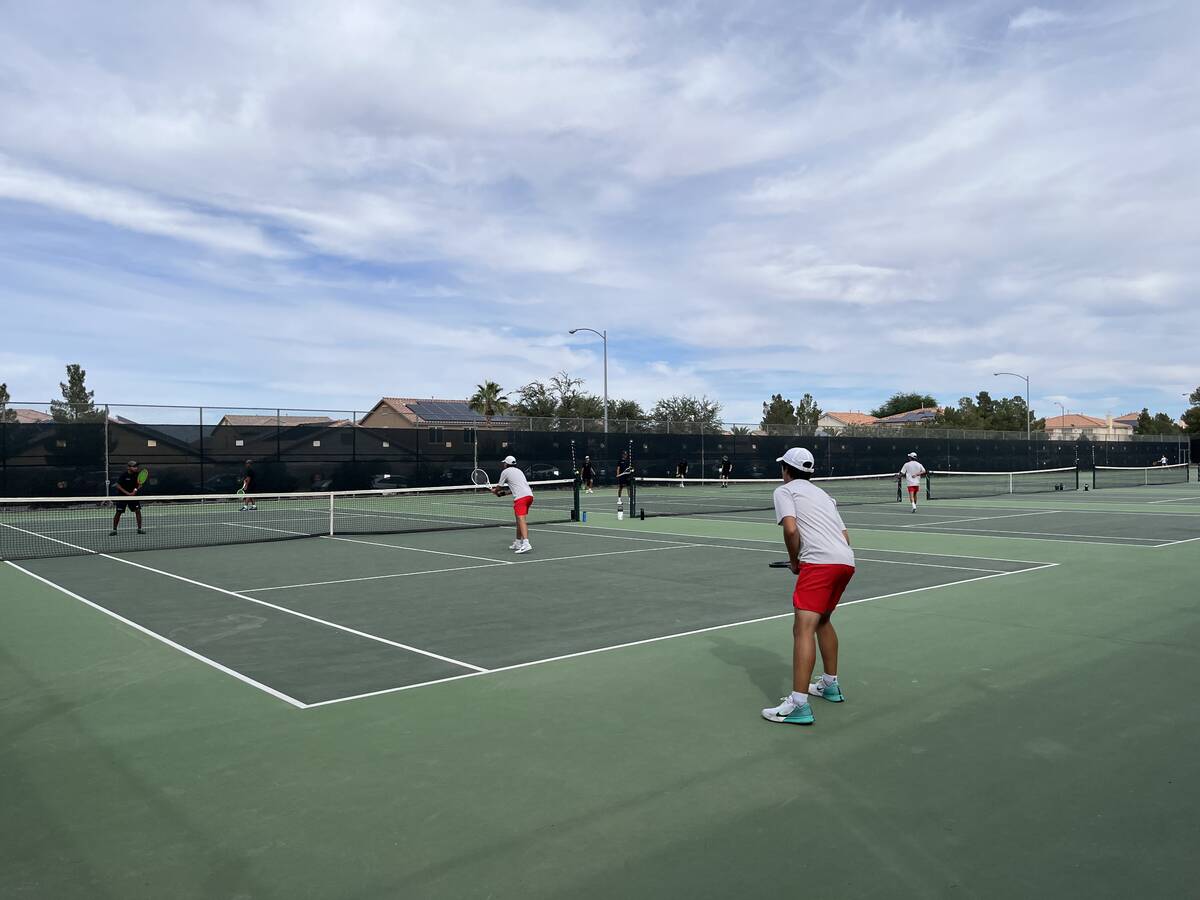 The boys doubles teams from Palo Verde (black shirts) and Coronado (gray shirts) play a match d ...