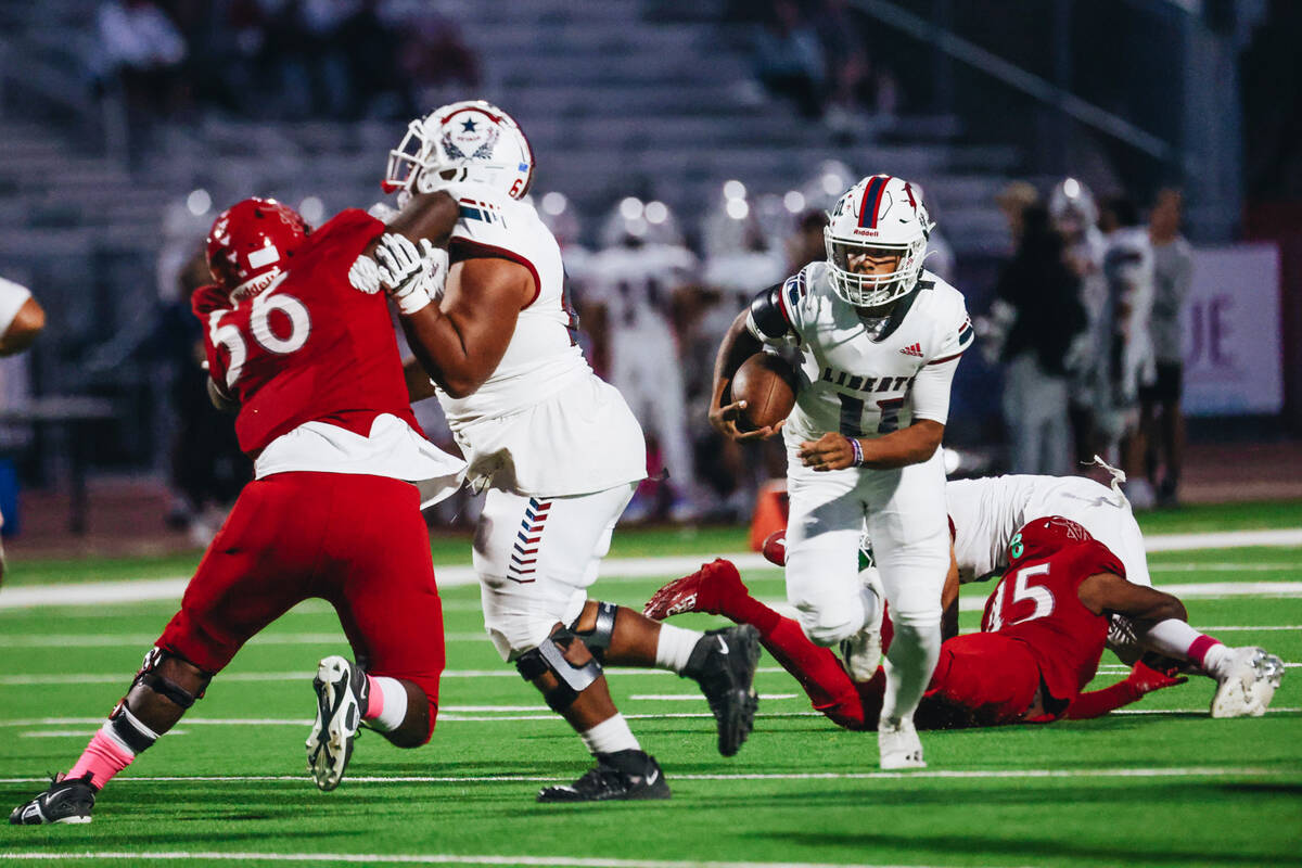 Liberty quarterback Tyrese Smith (11) runs the ball down the field during a game against Arbor ...