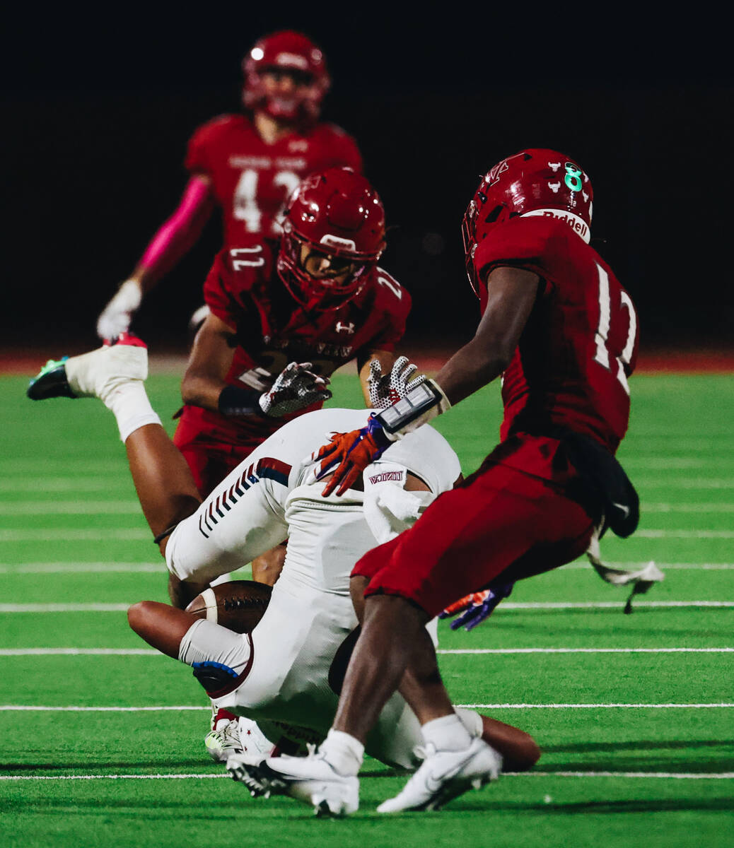 Liberty linebacker Andre Porter (2) lands on his head after successfully catching the ball duri ...