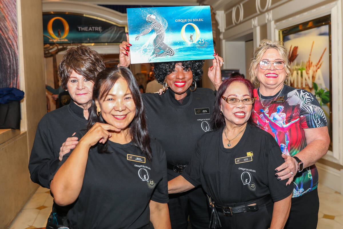 A group of theater ushers who have worked at Cirque du Soleil shows for over 25 years pose alon ...