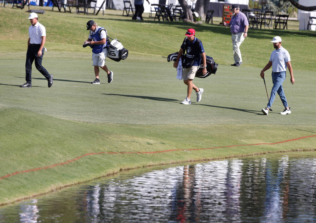 Cameron Champ, left, and Erik Van Rooyen, right, walk toward the ninth green during the Shriner ...