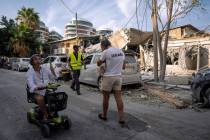 Israelis inspect the rubble of a building a day after it was hit by a rocket fired from the Gaz ...