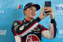 Christopher Bell films a video of himself after winning the pole position for the NASCAR Cup Se ...