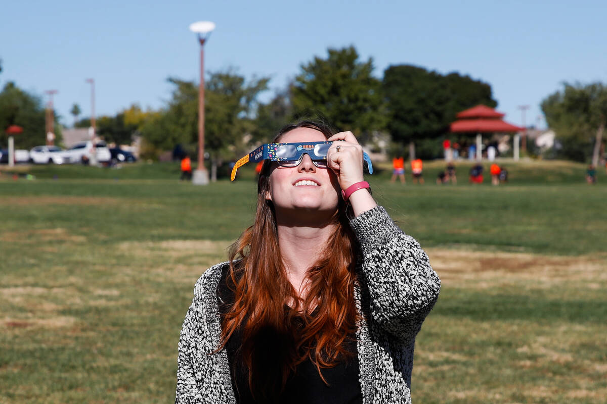 Miranda Harris views the annular solar eclipse as it passes over Las Vegas on Saturday, Oct. 14 ...