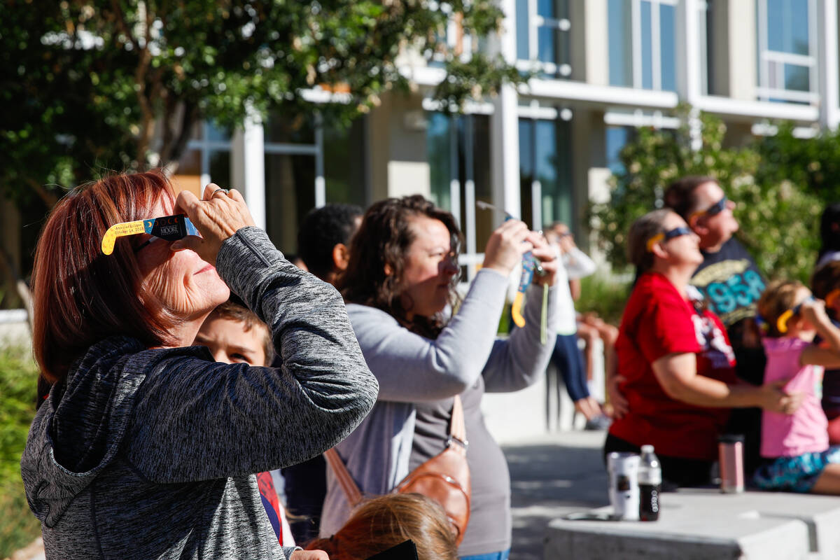 People view the annular solar eclipse from the Centennial Hills Library as it passes over Las V ...