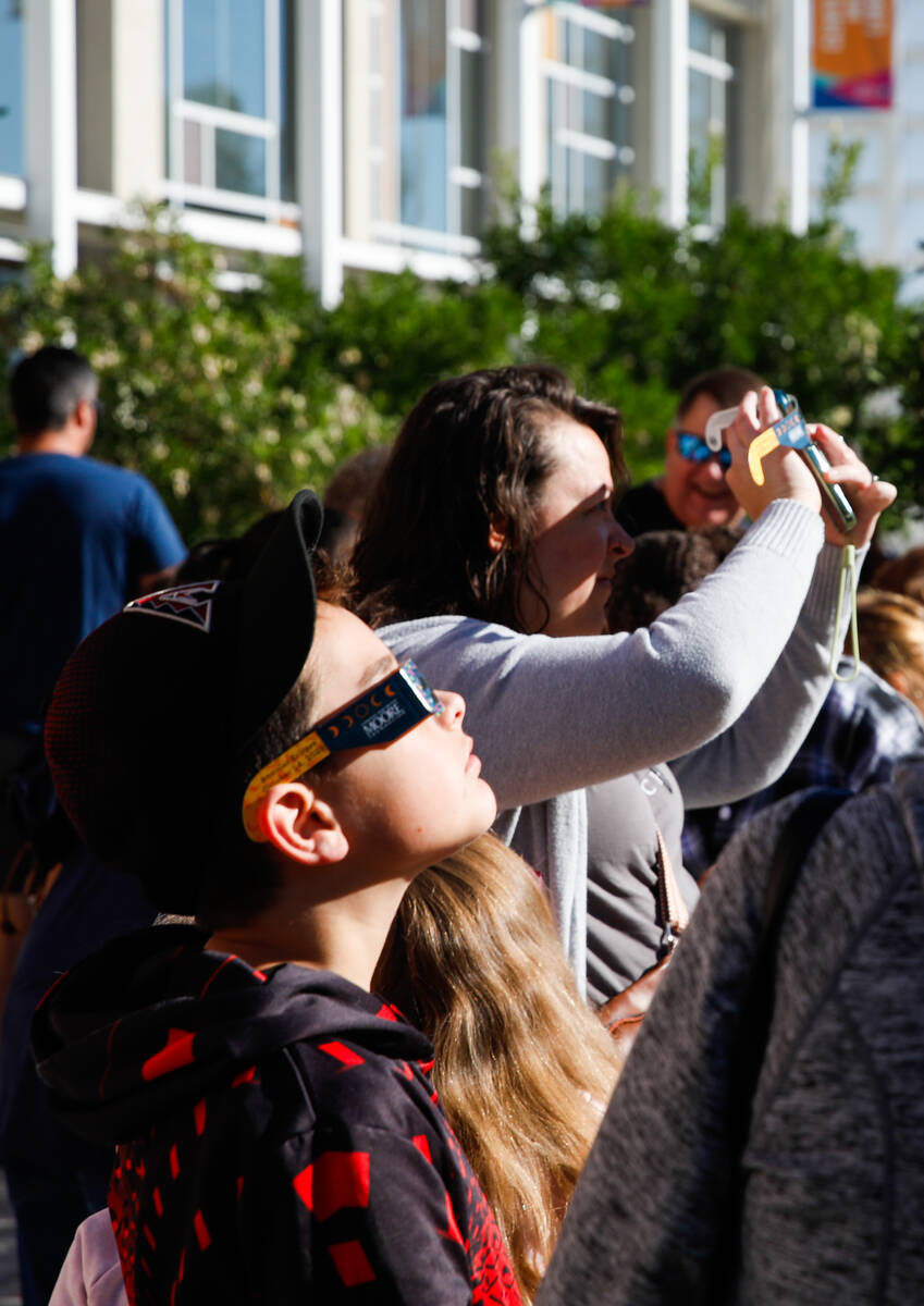 People view the annular solar eclipse from the Centennial Hills Library as it passes over Las V ...