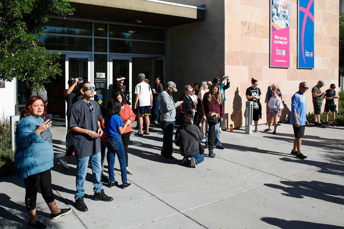 People view the annular solar eclipse from the Centennial Hills Library as it passes over Las V ...