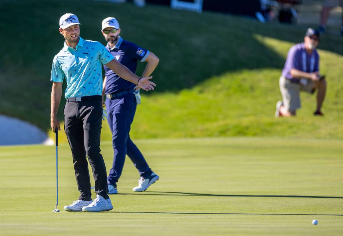 Adam Svensson looks to a short putt on the green at hole 18 with Adam Hadwin behind during day ...