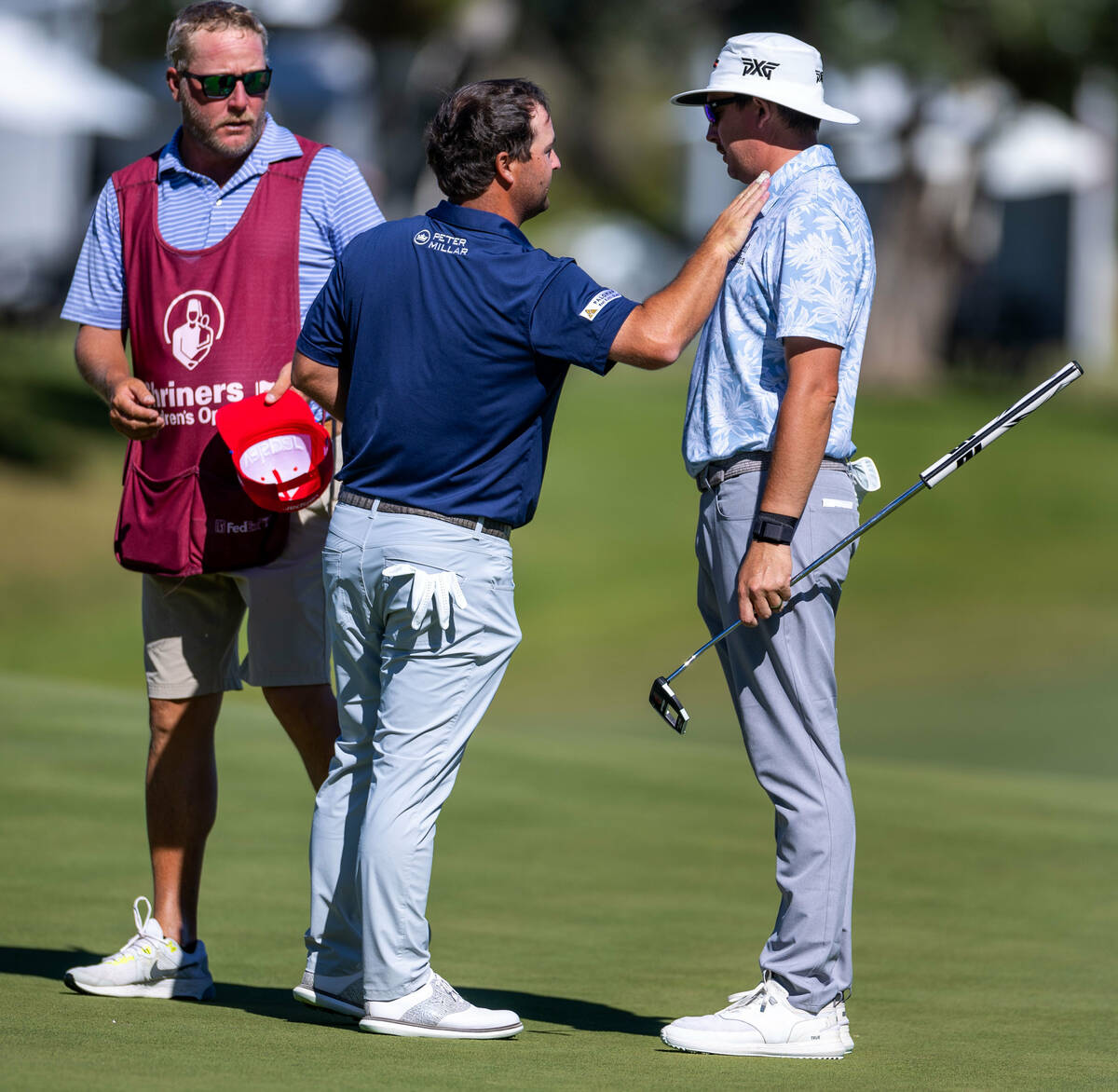 Joel Dahmen, left, consoles Greyson Sign on hole 18 during day 3 play at the Shriners Children' ...