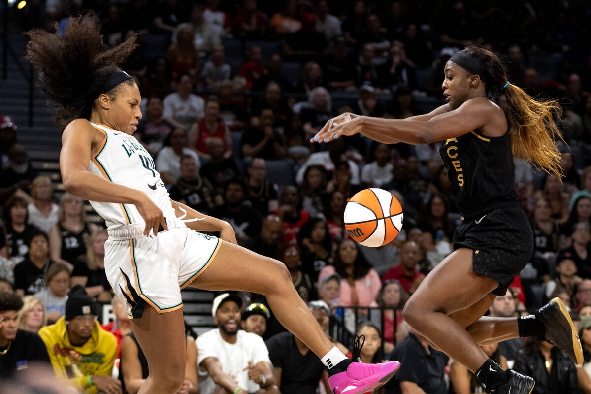 Las Vegas Aces guard Jackie Young (0) steals the ball on a pass by New York Liberty forward Bet ...