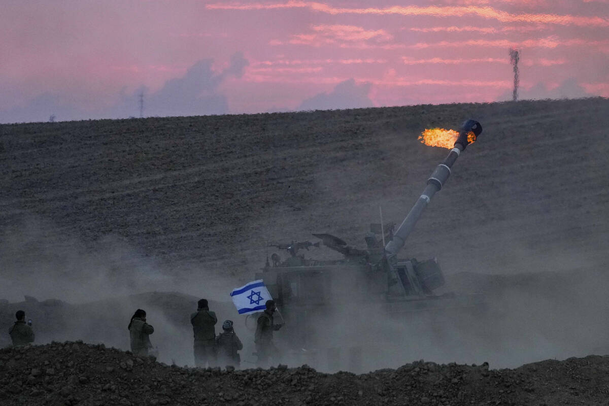An Israeli mobile artillery unit fires a shell from southern Israel toward the Gaza Strip, in a ...
