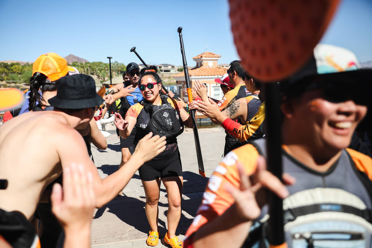 Melisa Mayeda high-fives her teammates on team Ripple Effect after racing at the Nevada Dragon ...