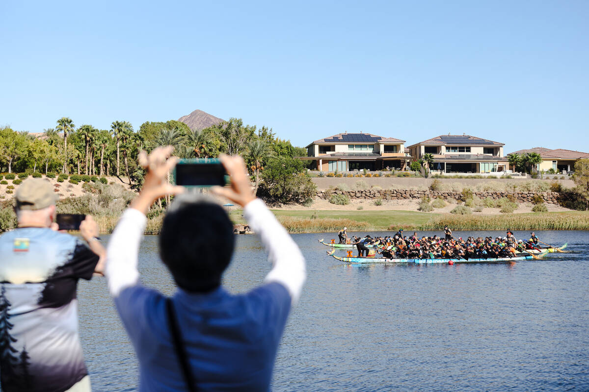 Spectators film contestants race to the finish line at the Nevada Dragon Boat Festival at Lake ...