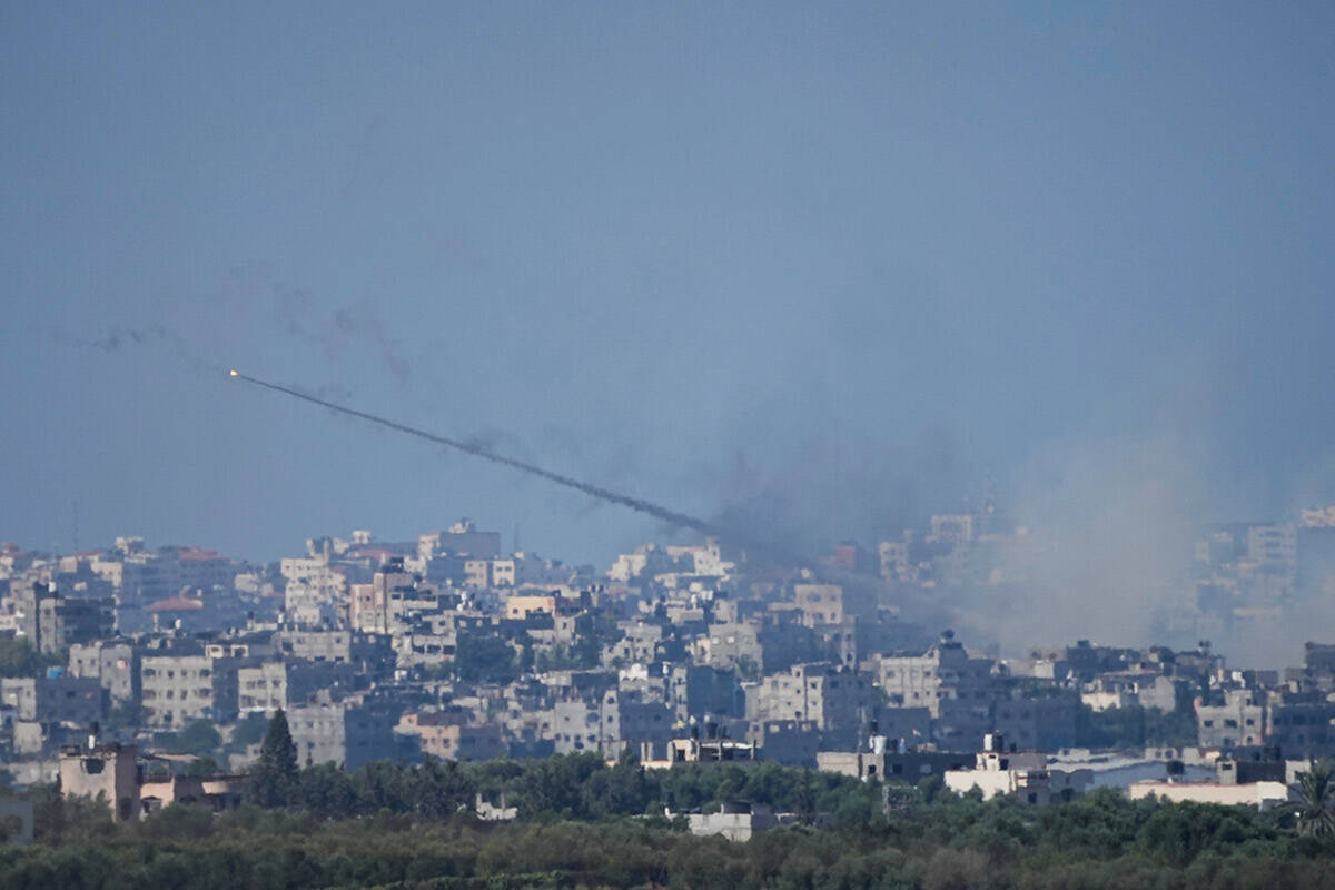 Rockets are fired toward Israel from the Gaza Strip, as seen from southern Israel, Sunday, Oct. ...