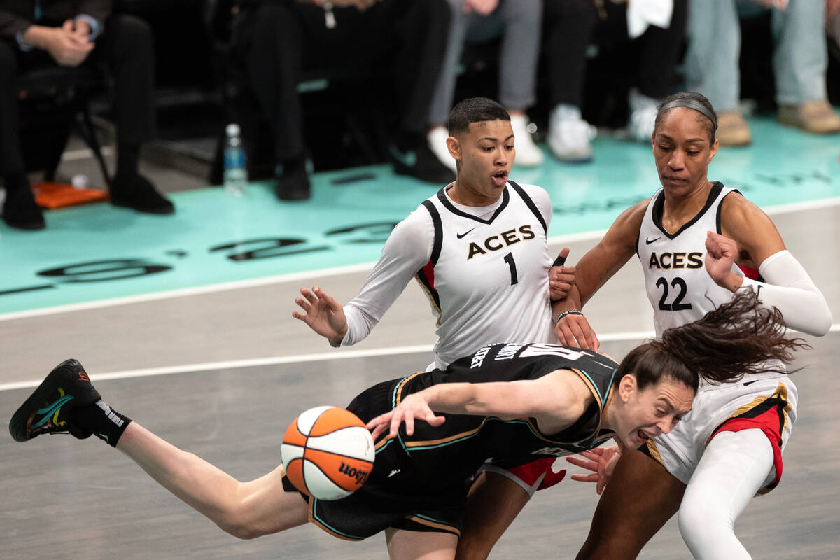 Las Vegas Aces guard Kierstan Bell (1) fouls New York Liberty forward Breanna Stewart (30) unde ...