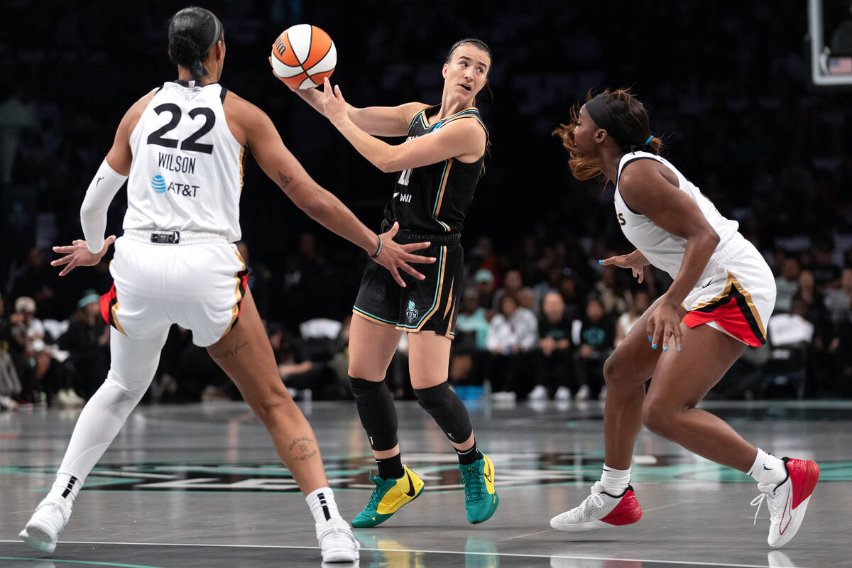 New York Liberty guard Sabrina Ionescu (20) passes backward while Las Vegas Aces forward A'ja W ...