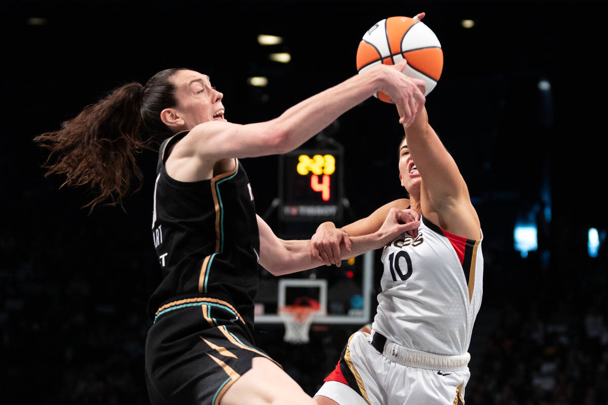 Las Vegas Aces guard Kelsey Plum (10) knocks the ball away from New York Liberty forward Breann ...