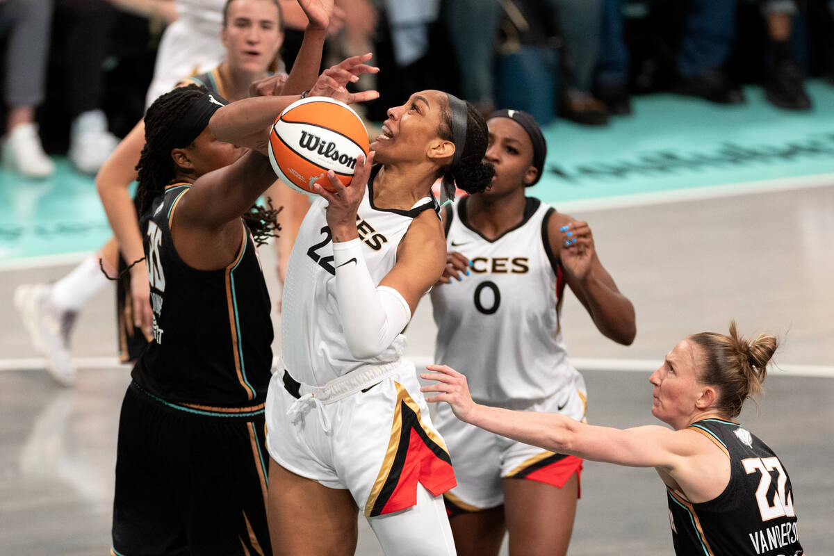 Las Vegas Aces forward A'ja Wilson (22) fights toward the hoop against New York Liberty forward ...