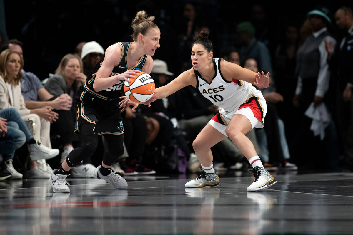 Las Vegas Aces guard Kelsey Plum (10) defends while New York Liberty guard Courtney Vandersloot ...