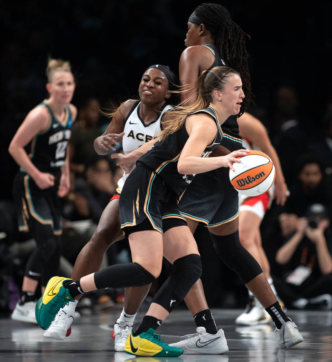 New York Liberty guard Sabrina Ionescu (20) drives around Las Vegas Aces guard Jackie Young (0) ...