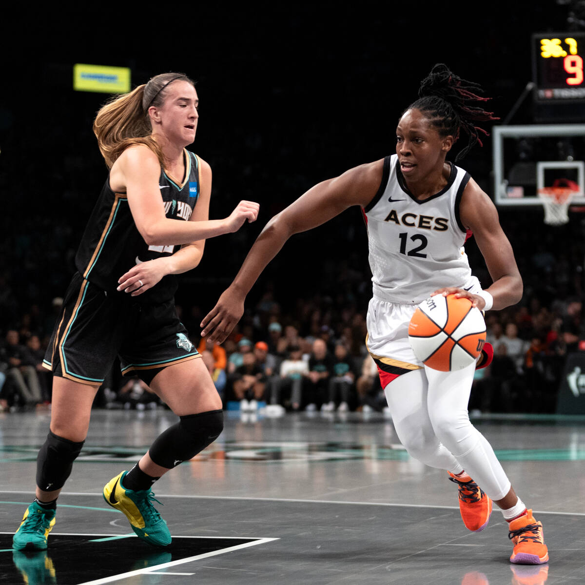 Las Vegas Aces guard Chelsea Gray (12) drives around New York Liberty guard Sabrina Ionescu (20 ...