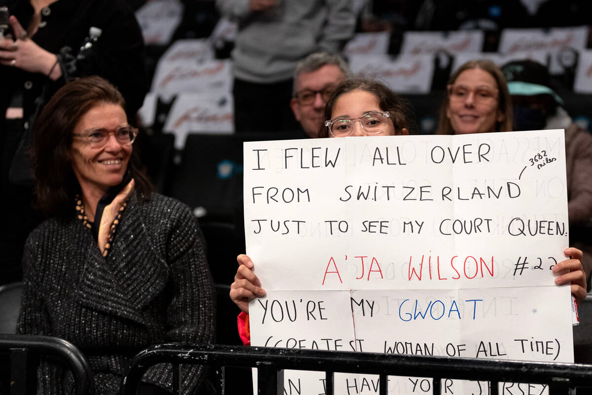 Las Vegas Aces fan Sofia Gaillard, 13, holds up a sign for her favorite player, Aces forward A& ...