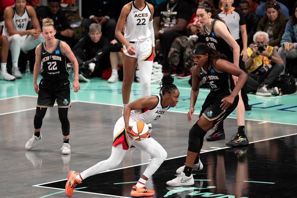 Las Vegas Aces guard Chelsea Gray (12) dribbles toward the hoop against New York Liberty forwar ...