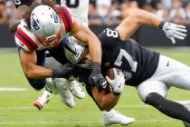 Raiders tight end Michael Mayer (87) is tackled by New England Patriots linebacker Jahlani Tava ...