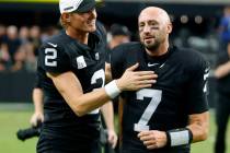 Raiders quarterback Brian Hoyer (7) and place kicker Daniel Carlson (2) leave the field after d ...