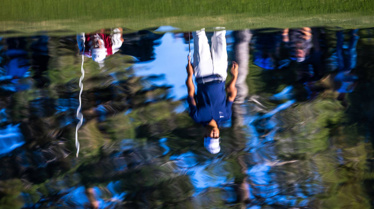 Tom Kim is reflected in the water while putting on the green at hole 17 during final day play a ...