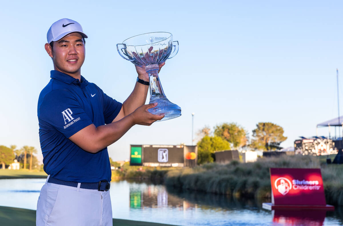 Tom Kim raises the winning trophy on final day play at the Shriners Children's Open from TPC Su ...