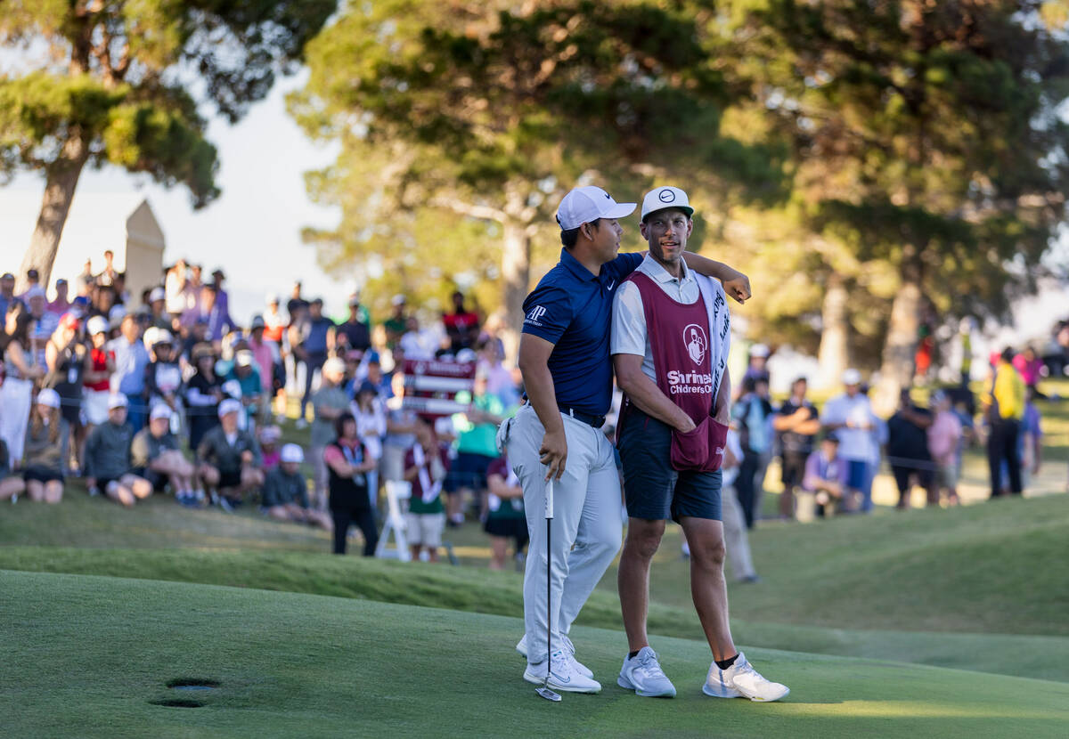 Tom Kim and his caddie Joe Skovron enjoy the win on hole 18 in final day play at the Shriners C ...