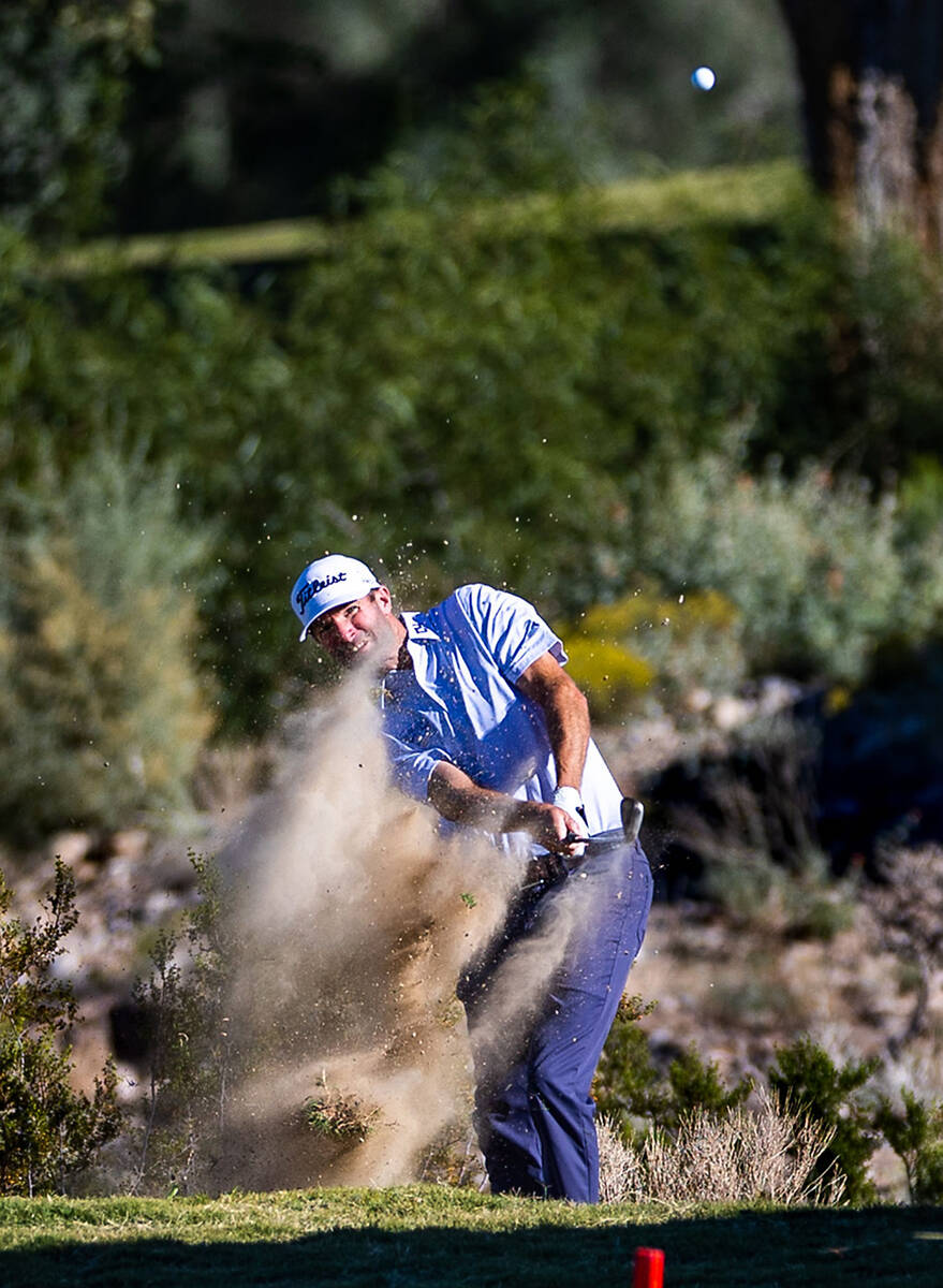 Nicholas Lindheim blasts out of the natural barrier along the fairway of hole 18 during final d ...