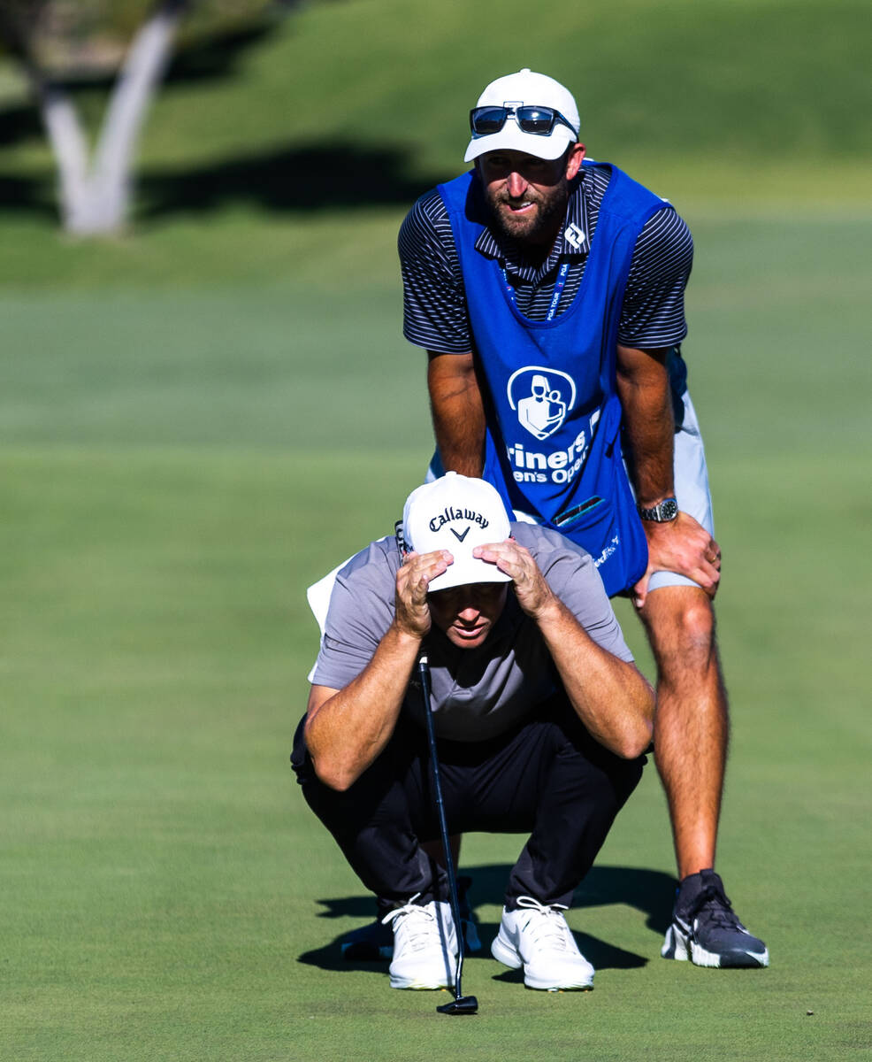 Alex Noren and his caddie struggle to read the green on hole 18 during final day play at the Sh ...