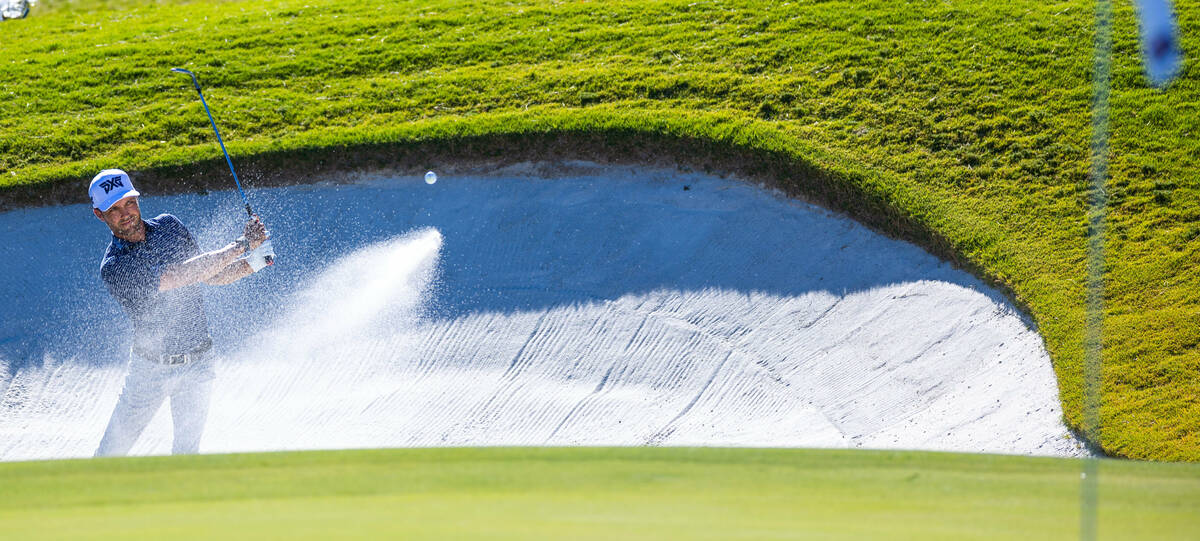 Eric Cole wedges out of the sand trap at hole 16 during final day play at the Shriners Children ...
