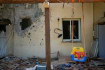 A children's swing hangs in a house damaged by Hamas militants is seen in Kibbutz Be'eri, Israe ...