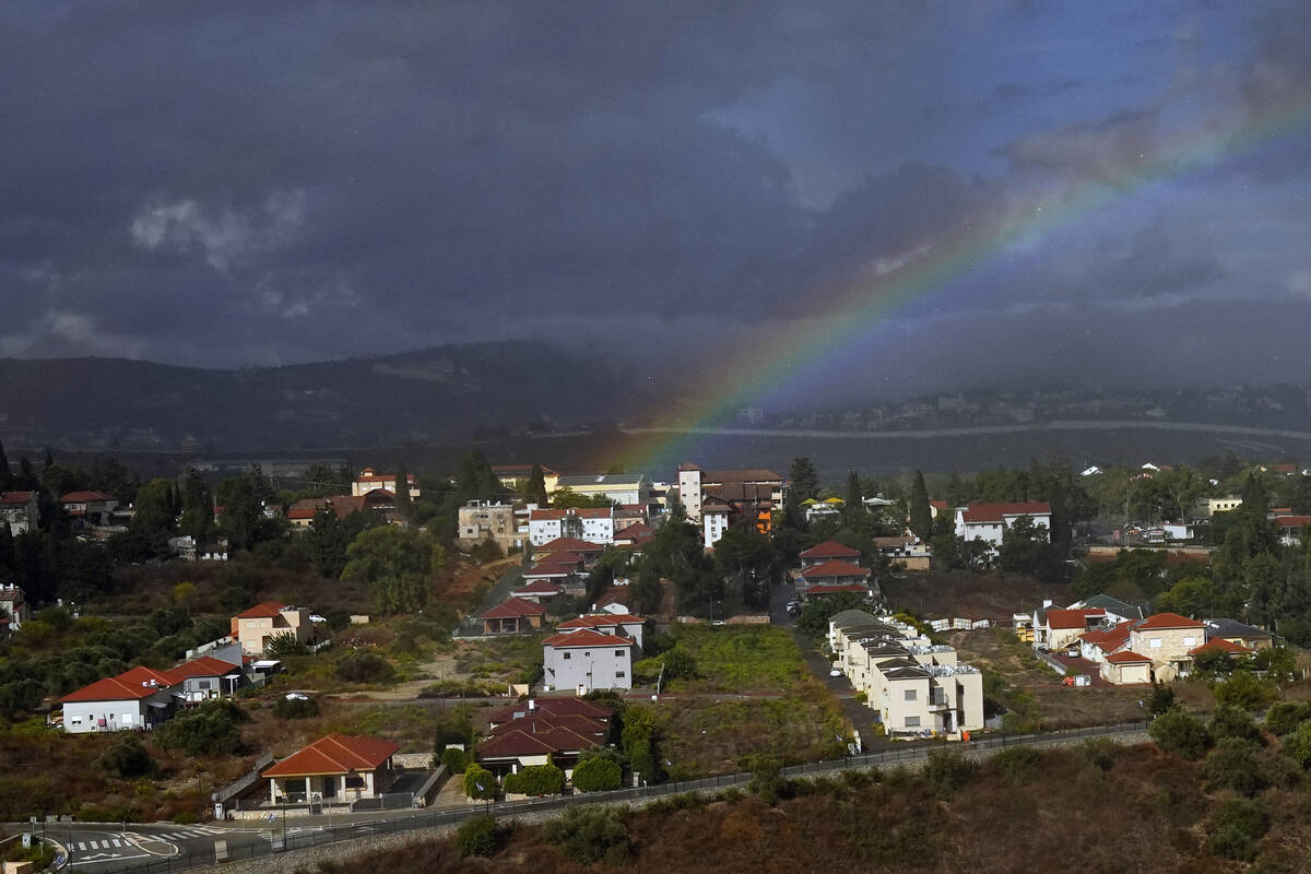 Rainbow appears over the Israeli town of Metula, as seen from the Lebanese side of the Lebanese ...
