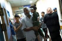 Palestinians wounded in Israeli bombardment of the Gaza Strip arrive at a hospital in Khan Youn ...