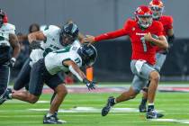 UNLV quarterback Jayden Maiava (1) runs upfield from Hawaii linebacker Isaiah Tufaga (17) durin ...