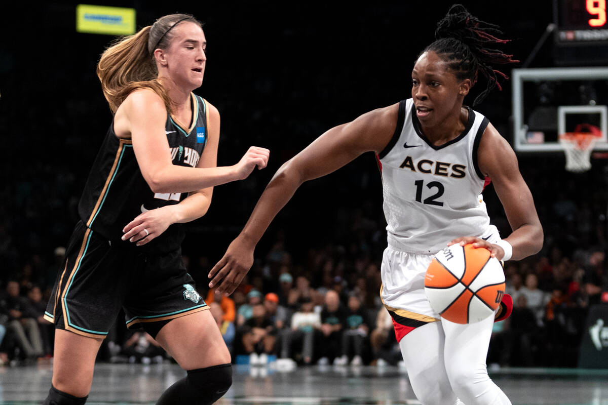 Las Vegas Aces guard Chelsea Gray (12) drives around New York Liberty guard Sabrina Ionescu (20 ...