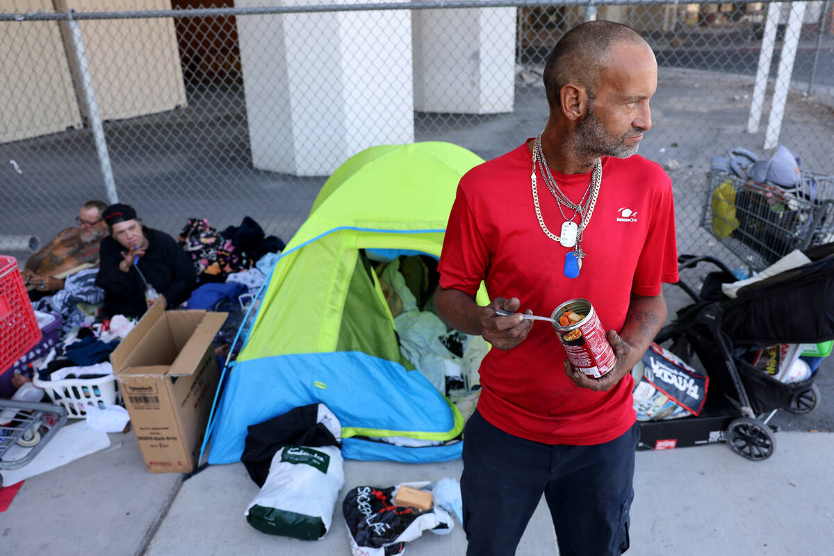 Marcus Copeland, 43, eats lunch at his shelter on 9th Street under the U.S. Highway 95 bridge i ...